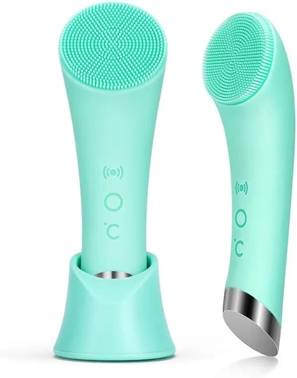 green heated facial cleansing brush standing in its base
