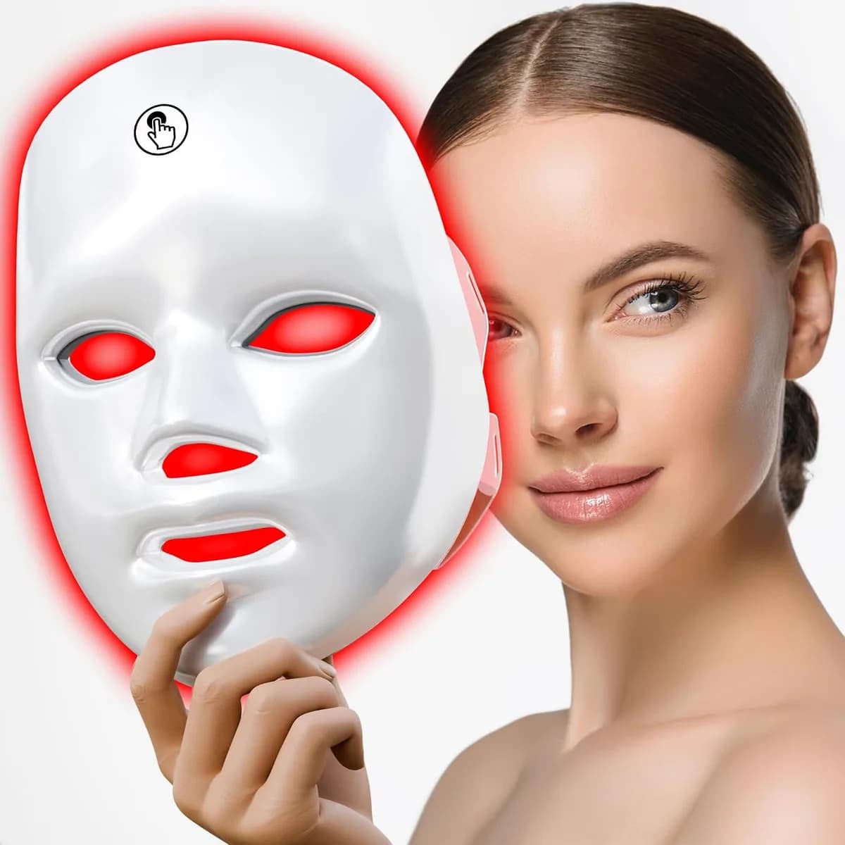 white LED face mask glowing red held next to a woman's face