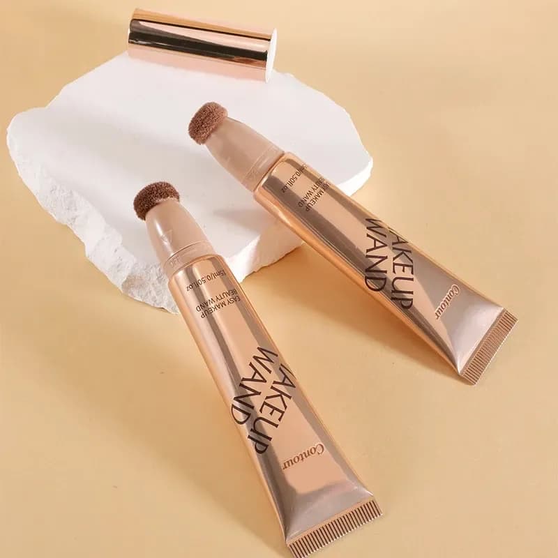 two liquid contour wands with cushion applicator tips on a stone block
