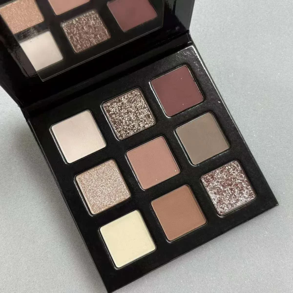 mini neutral eyeshadow palette open showing 9 matte and shimmer shades